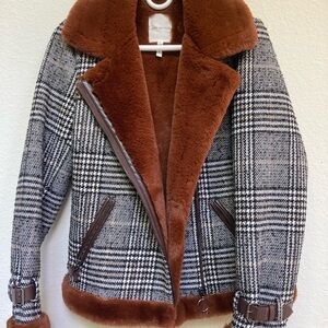 Bomber style winter jacket.  Brown faux fur lining.  Black and white plaid.